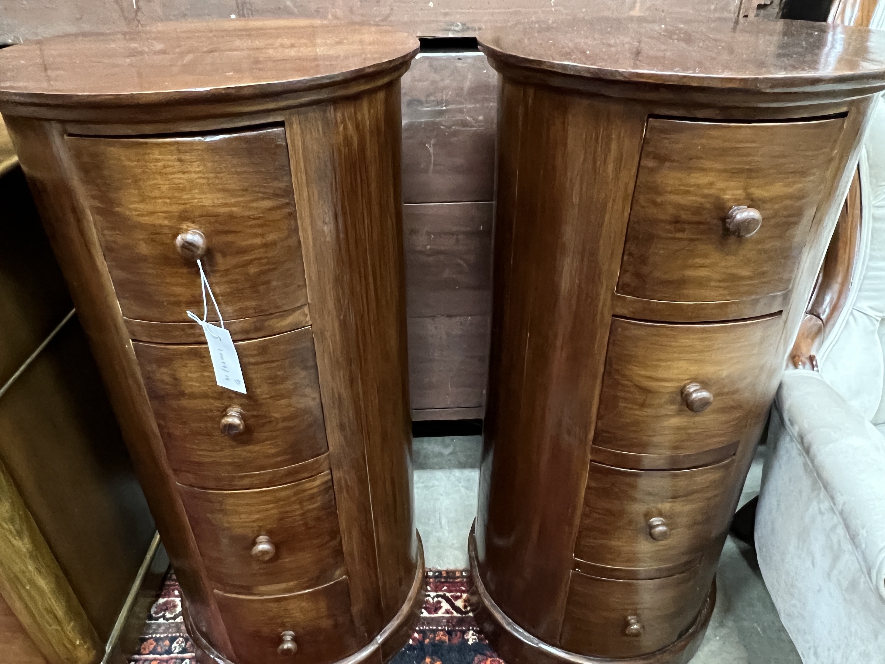 A pair of reproduction mahogany cylindrical bedside cupboards, each fitted four small drawers, diameter 41cm, height 85cm